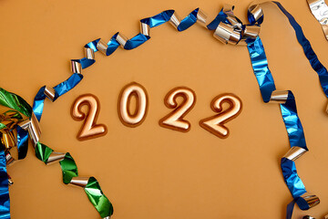 Holiday background  Numbers of year 2022 made by gold candles on bokeh festive sparkling background. celebrating New Year holiday, close-up. Space for text