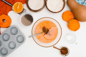 step-by-step recipe for pumpkin cupcakes in a baking dish with chia seeds, autumn orange pie with orange. ingredients for pumpkin pie top view . mixing ingredients
