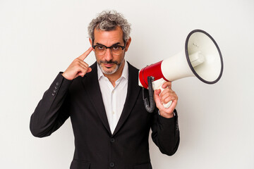 Middle age business man holding a megaphone isolated on white background  pointing temple with finger, thinking, focused on a task.