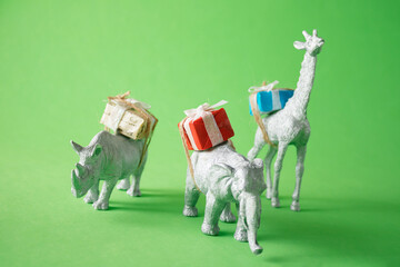 The animals bring gifts. Green background. Minimal party or birthday concept.