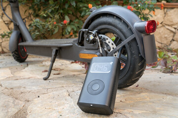 Electric scooter rear tire pressure check, complete the missing air pressure with an electric air...