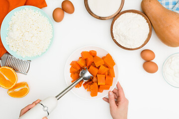 step-by-step recipe for pumpkin curd casserole in the shape of a zebra, orange autumn pie with orange. mixing ingredients for pumpkin pie top view