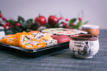 Sushi nigiri and maki set  with Christmas or New Year concept background. Traditional japanese food. © Laia