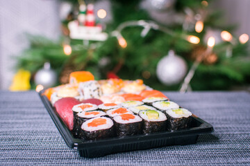 Sushi nigiri and maki set  with Christmas or New Year concept background. Traditional japanese food.