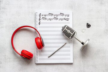 Sheets with music notes and headphones. Compose music concept
