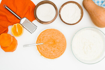 step-by-step recipe for pumpkin curd casserole in the shape of a zebra, orange autumn pie with orange. ingredients for pumpkin pie are visible from the top