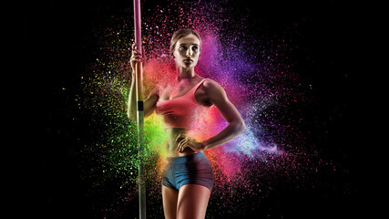 Creative portrait of young female athlete, sportive woman standing in explosion of colored neon...