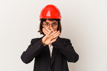 Young architect woman with red helmet isolated on white background doing a denial gesture