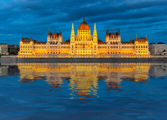 Fototapeta na wymiar Hungarian Parliament building at sunset with reflection in Danube river, Budapest, Hungary