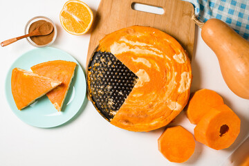 pumpkin casseroles with zebra-shaped cottage cheese, autumn orange pie. cut the pie into pieces on a plate . © Taranova_ksenya