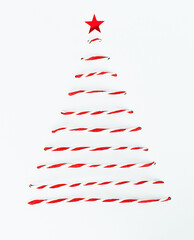 Christmas tree made of red and white thread with a red star on a light background