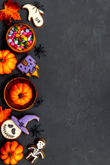 Flat lay pattern of halloween cookies and sweets. Party background