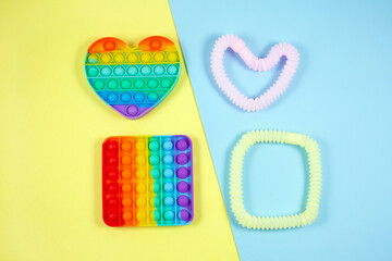 Multicolored bright tubes and pop it on color background.