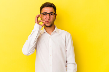 Young caucasian man with tattoos isolated on yellow background  with fingers on lips keeping a secret.