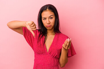 Young latin woman isolated on pink background  showing that she has no money.