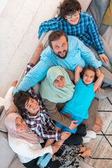 Top view photo of an Arab family sitting in the living room of a large modern house.Selective focus 