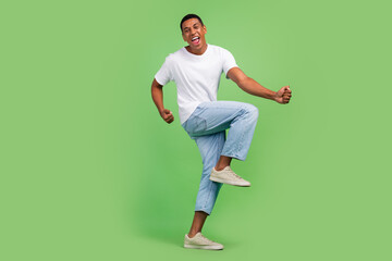 Fototapeta na wymiar Full size profile side photo of young excited afro guy good mood rejoice victory isolated over green color background