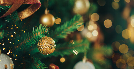 Obraz na płótnie Canvas Artificial Christmas tree branch with baubles and garland.