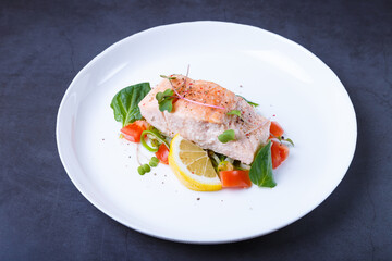 Trout (salmon) with vegetables, lemon and microgreens, cooked by the confit method. Traditional French dish. Step by step. Close-up.