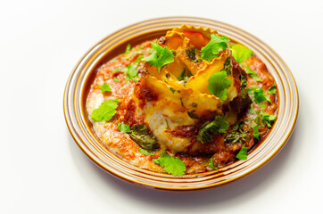 Hand rolled four cheese ravioli pasta in minced beef with Chianti red wine, garlic and herb ragu, and a bechamel sauce topped with pecorino cheese crumb and finished with fresh parsley