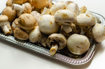 Portobello and white mushrooms on a silver plate, vegetables from an organic farm