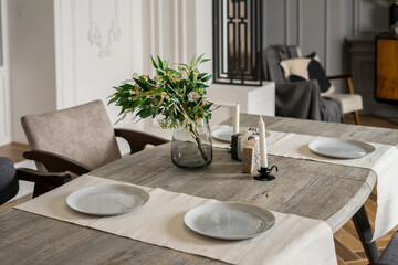 modern dinning room with modern chair and vase of plant on table