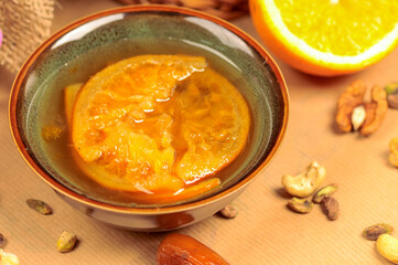orange jam in a small brown gravy boat
