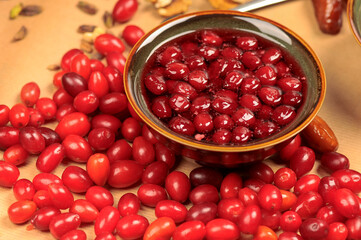 cranberry jam in a small brown gravy boat on a background with cranberries
