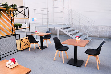 Modern Stylish Interior Of A Street Cafe Or Restaurant. Empty outdoor Tables and Chairs on the street