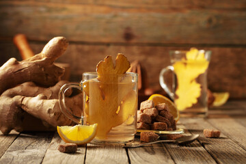 Ginger tea with ingredients on an old wooden table.
