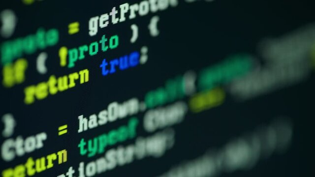 Close up of monitor screen with developing programming and coding technologies. Programmer or hacker is typing code on keyboard. Concept of bitcoin btc mining and development in virtual cyber space