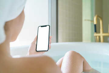 phone blank screen display in woman hand, relax in bathtub with - 469306762