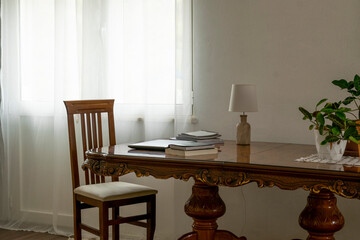 Home workspace design, interior living room workspace with antique table, personal computer and books