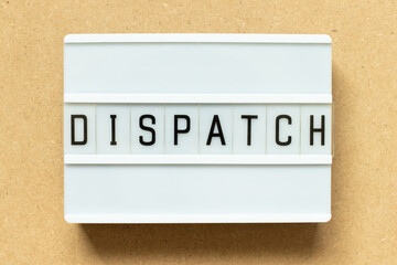 Lightbox with word dispatch on wood background
