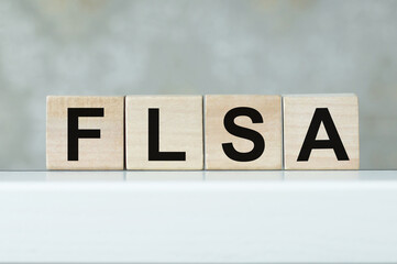 FLSA letters on wooden cubes on an insulated table