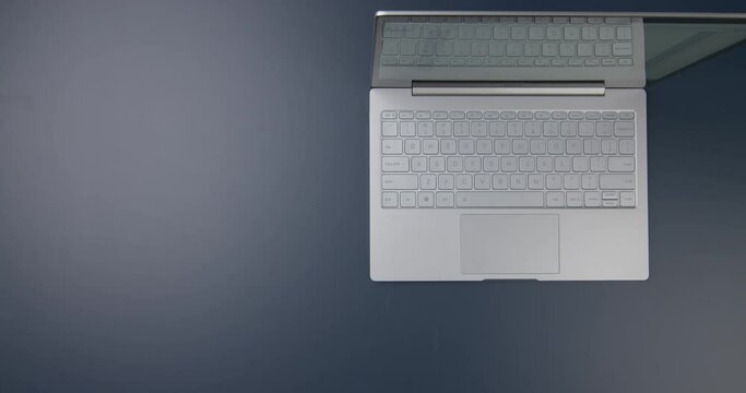 Workspace with laptop, tablet and woman typing on keyboard. View from above.