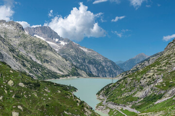 Naklejka na ściany i meble View from the Grimsel Pass road to the lake Raeterichsbodensee near Guttannen