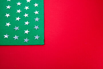 Christmas stars on a green background with red and white stripes in the form of an American flag.