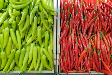 Fresh green and red chili selling on market stall. Top view image.