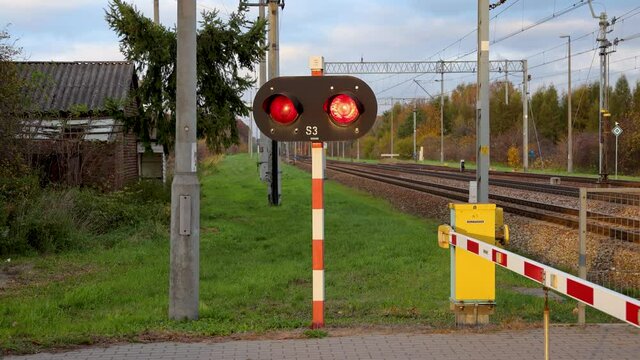 Level crossing red signals on railroad crossing in Rogow, Lodz Province of Poland, 4k video