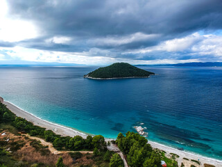 Aerial panoramic view over Milia beach in Skopelos island, against a cloudy sky in Sporades, Greece