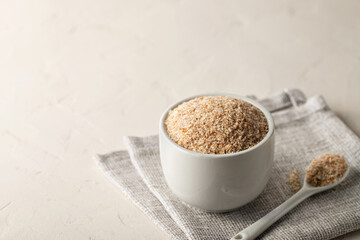 A pile of psyllium husks in a bowl on the table. Dietary supplement, superfood. Copy space