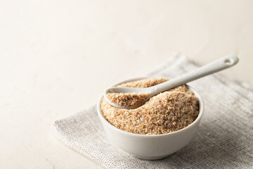 A pile of psyllium husks in a bowl on the table. Dietary supplement, superfood. Copy space