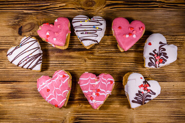 Cookies made in shape of heart on the wooden background. Top view