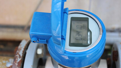 Blue digital water meter. Dirty electronic tap water flow meter with digital display. Close-up and...