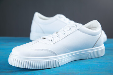 Pair of new stylish white sneakers.