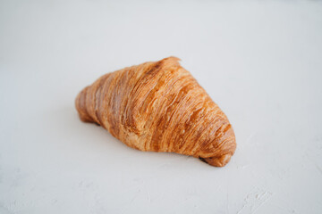 Plain croissant on white table. French pastry