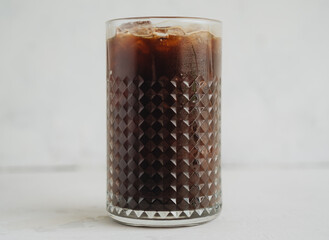 Iced americano coffee in a glass on white background
