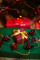 Beautiful Christmas gift boxes. Colored Presents for Birthdays. Boxes with gifts tied with ribbon and bows background. craft paper present box. Christmas tree toys and lights. happy new year 2022.