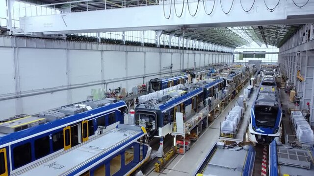 Automobile factory interior. Industrial plant, industrial workers at, automobile factory, trams, metro trains production factory facility.